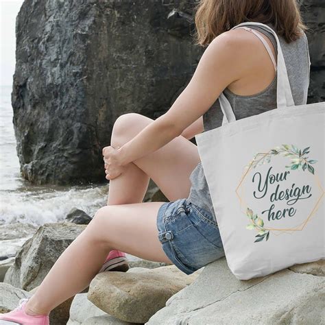 Download Woman in the park holding tote bag mockup.